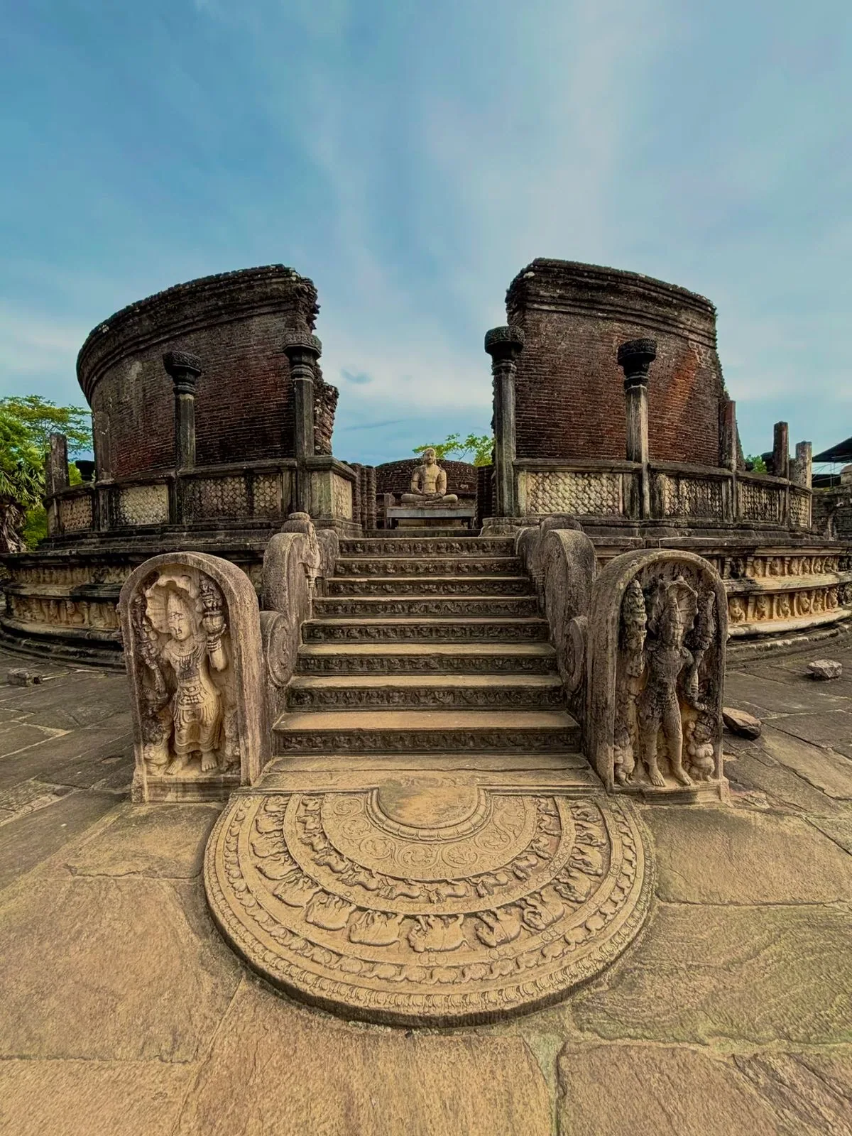 Carved stonework and circular shrine remains at an ancient Sri Lankan heritage site.