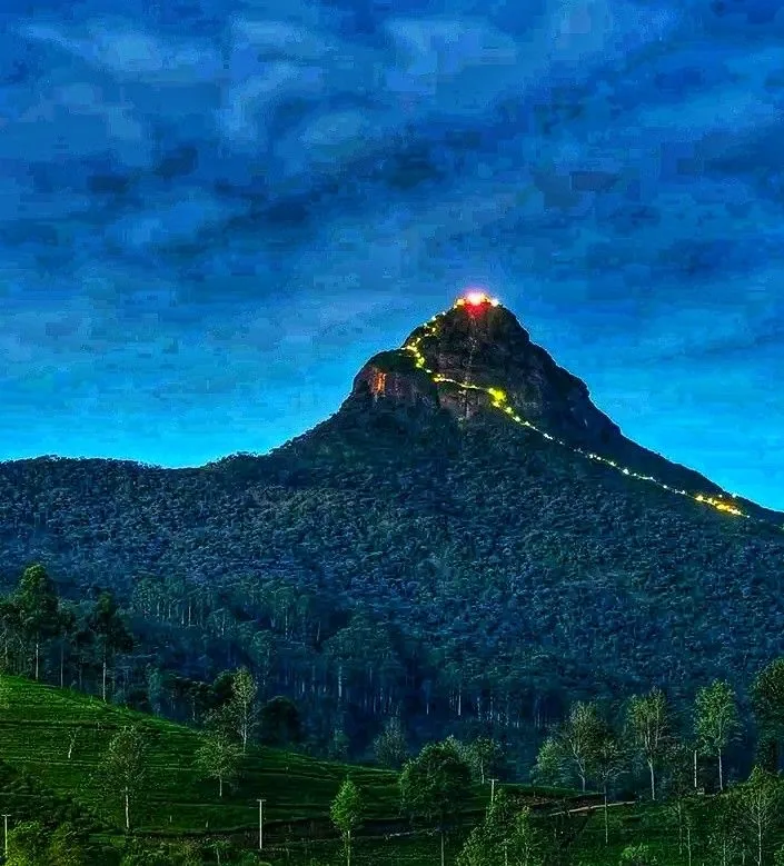 Pilgrims' lights trace the mountain path toward the summit of Sri Pada after dark.
